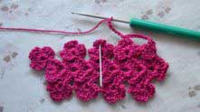 Ch 7, sc in the center of next flower (needle marked).