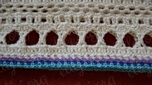 Here is a bit of crochet stitch "of the head". I have not photo, but after light blue row I work one same row of milky yarn and one row of ch-3 arches.