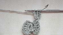 Work 2 unfinished tr. Yarn over, and pull through all loops on the hook.