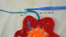 Work ch 11. 1 sc in the center dc on the petal (blue marker).