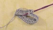 2 yarn over (YO), insert hook under dc. Yarn over and pull loop.