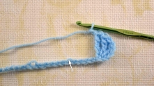 Work ch 1 v.p. Skip 5 ch, single crochet (sc) in the next ch.