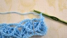 Work ch 1. 3 tr in common top of FPtrs of the previous row (needle marked).