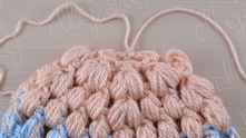Tighten the thread between puff stitches.