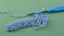 Work 2 unfinished dc, yarn over, and pull through all loops on the hook.