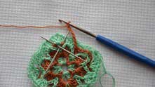 Continue working the arch of Ch 6. Sc in the places marked with needles.
