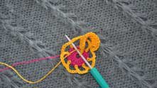 Insert hook in dc of previous round (as at the photo). Yarn over, and pull through all loops on the hook.